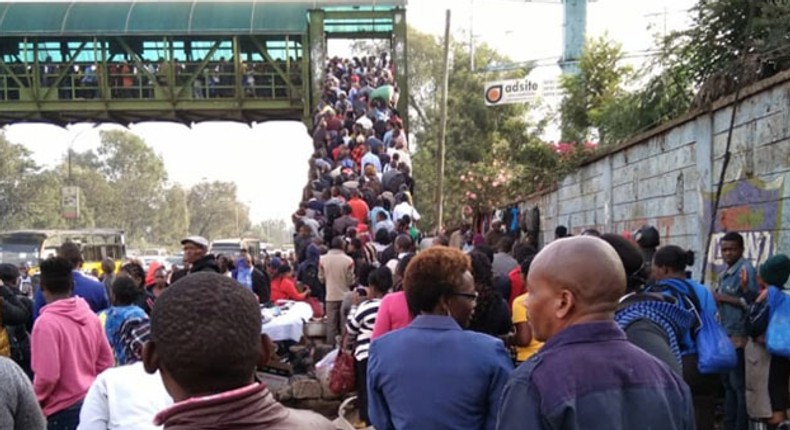 Kenyans walk after the ban of matatus from the CBD took effect