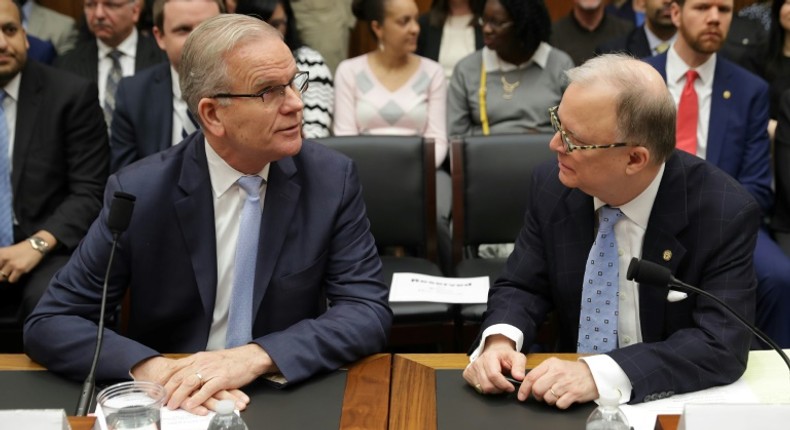 Federal Aviation Administration acting Administrator Daniel Elwell (L) and National Transportation Safety Board Chairman Robert Sumwalt talk before testifying at a House panel on the Boeing 737 MAX