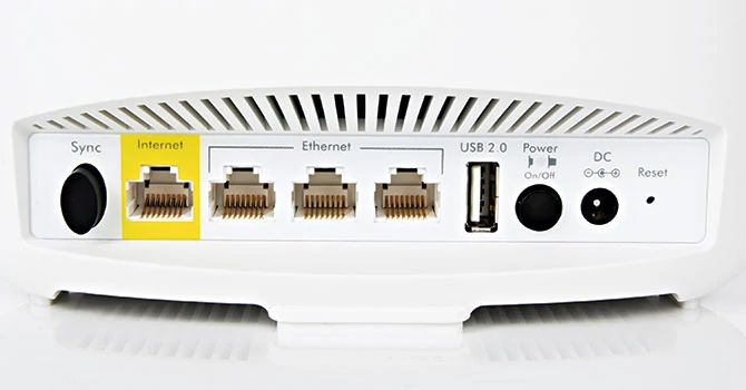 Tylna strona Netgear Orbi: przycisk Sync pozwala dodawać kolejne satelity już po konfiguracji urządzenia. Do gniazda LAN podłączamy kabel od rutera, kolejne porty LAN możemy wykorzystać dowolnie. Do tego dochodzi port USB, włącznik i zasilanie. Inne systemy mają mniej łączy.