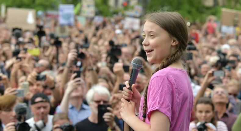 Swedish teenage activist Greta Thunberg addresses a rally in Berlin, while Chancellor Angela Merkel praised her nearby in the German capital