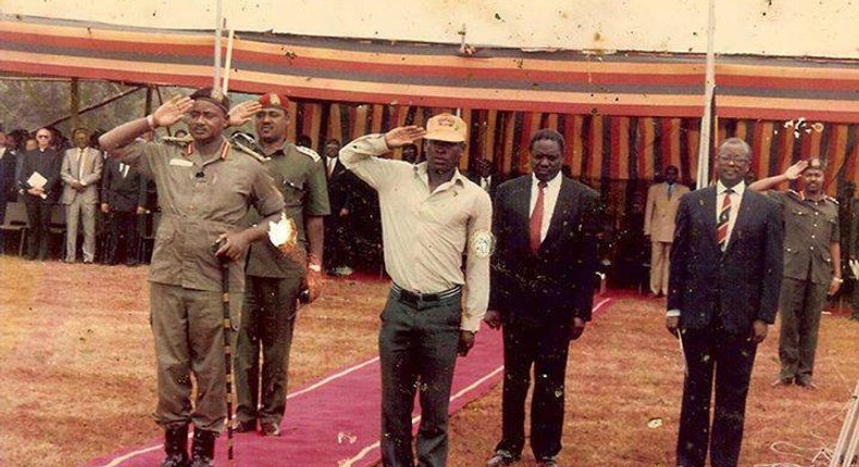 Mukwaya (right) salutes next to president Museveni 