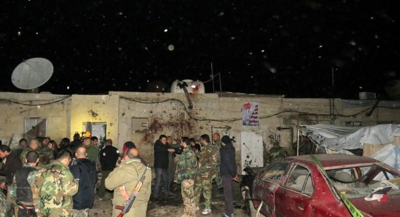 Syrian soldiers gather at the site of an attack in Kafr Sousa, southwest of the Syrian capital Damascus on January 12, 2017