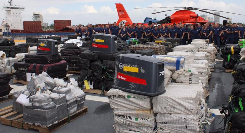 Bales of cocaine on display aboard the US Coast Guard cutter James, in front of the ship's crew and its helicopter, in Ft. Lauderdale, Florida, November 15, 2018.