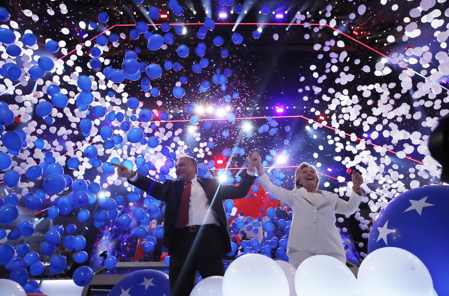 Hillary Clinton and her vice presidential running mate Senator Tim Kaine celebrate among balloons.