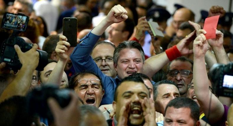 Malta's Minister within the Office of the Prime Minister, Konrad Mizzi (C) celebrates with Labour Party's supporters the results of Malta's general election on June 4, 2017 at a polling station in Naxxar