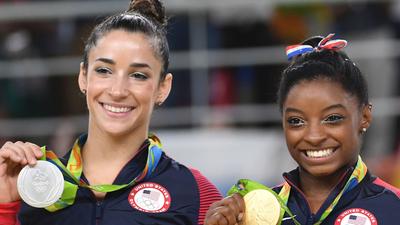 Aly Raisman (L) and Simone Biles (R) pose with their Olympic medals in 2016.TOSHIFUMI KITAMURA/AFP via Getty Images