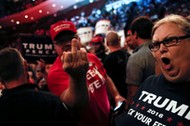 Supporters of Republican U.S. presidential nominee Donald Trump scream and gesture at members of the