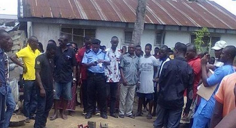 The angry mob with the charred remains of the mother-in-law