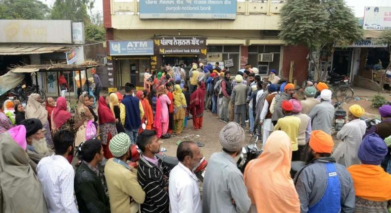 Villagers queue outside a bank in Khasa village, some 20kms from Amritsar, northwest India, as they wait to deposit and exchange 500 and 1000 rupees on November 12, 2016