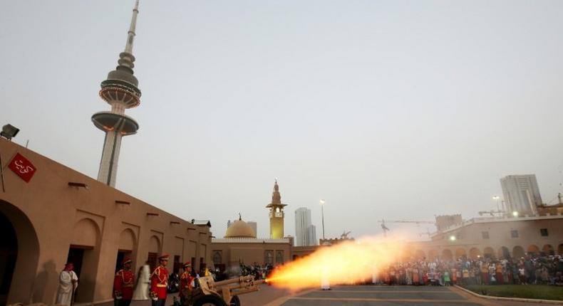 A picture taken on June 24, 2017 shows a cannon being shot at the Nayef Palace in Kuwait City signalling the end of the holy fasting month of Ramadan