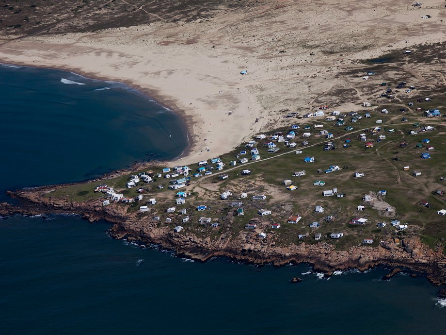 The tiny village of Cabo Polonio sits on the eastern coast of Uruguay. Filled with multi-colored houses, the village also includes a beach that visitors are transported to either by 4-wheel-drive trucks or by horse. The long beach is popular with windsurfers, with a sheltered crescent area of the beach allowing opportunities for swimming.