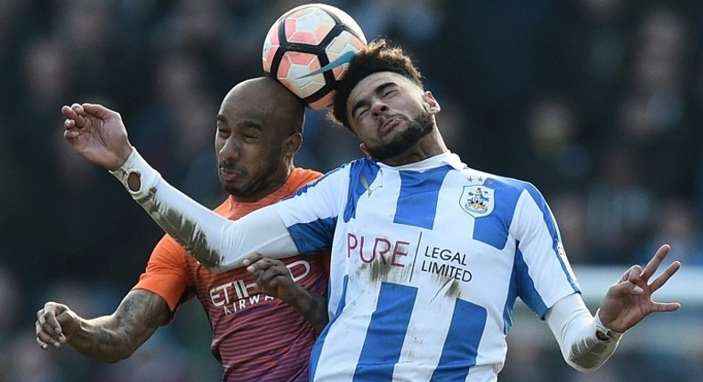 Huddersfield Town's Philip Billing (R) vies with Manchester City's Fabian Delph during their English FA Cup fifth round match on February 18, 2017