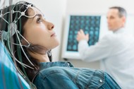 Charming young woman undergoing electroencephalography