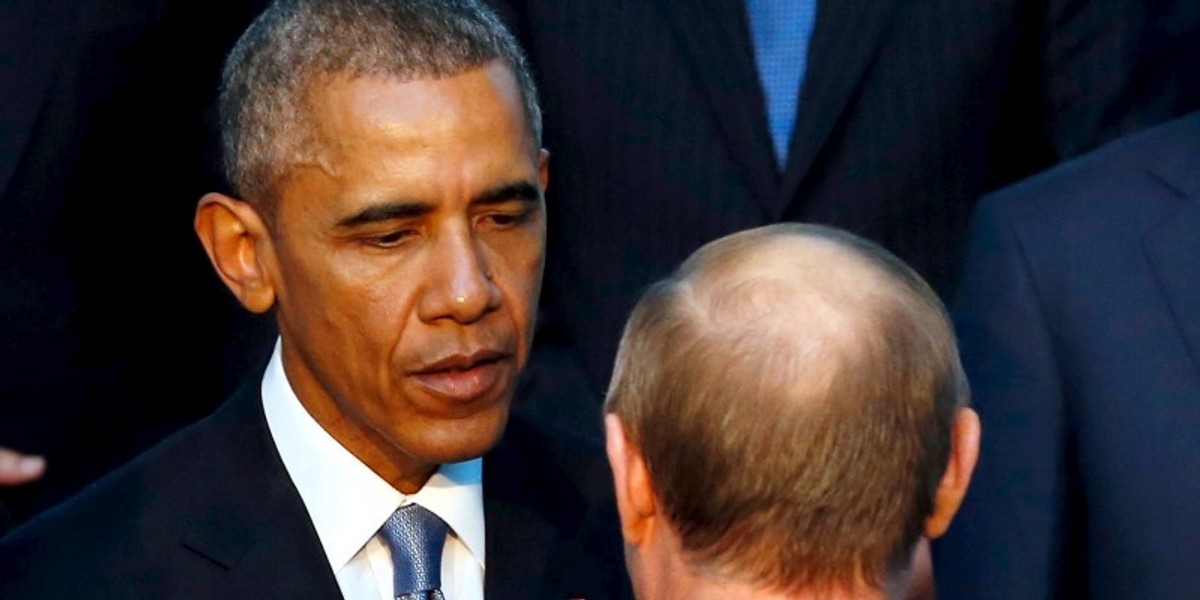 US President Barack Obama shakes hands with Russia's President Vladimir Putin (back to camera) as they gather for a family photo with fellow world leaders at the start of the G20 summit at the Regnum Carya Resort in Antalya, Turkey, November 15, 2015.