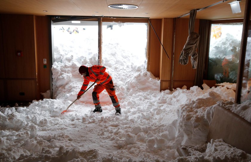 Workers shovel snow out of a restaurant after an avalanche at Santis-Schwaegalp mountain resort