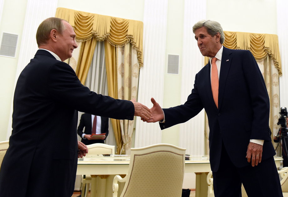 Russian President Vladimir Putin, left, shakes hands with US Secretary of State John Kerry.