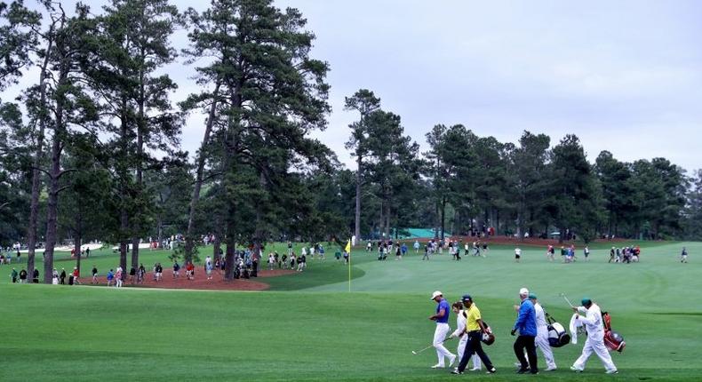 Jason Day of Australia, Yuta Ikeda of Japan and Sandy Lyle of Scotland, seen on the 16th hole during a practice round prior to the start of the 2017 Masters Tournament, at Augusta National Golf Club in Georgia, on April 3