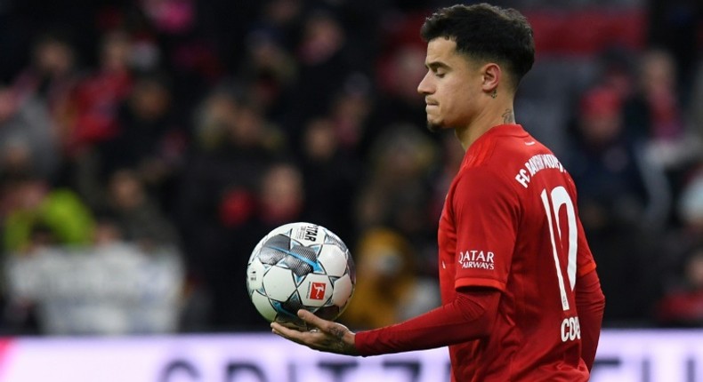 Philippe Coutinho walks off with the match ball after his hat-trick against Werder Bremen