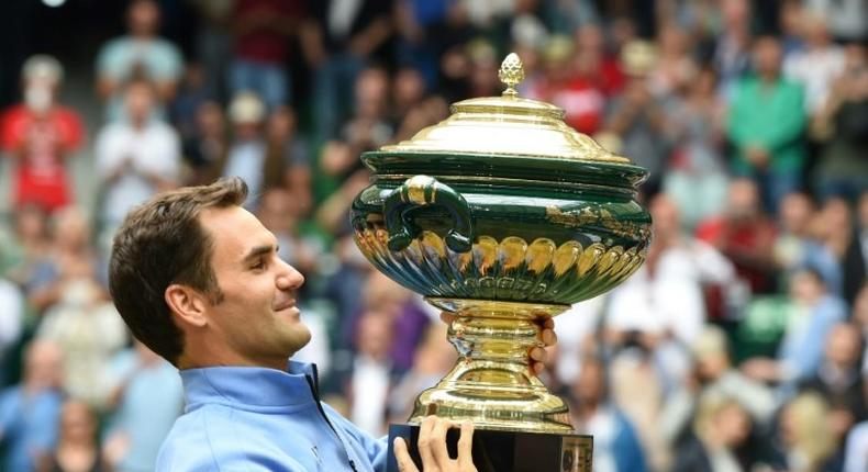 Roger Federer poses with his trophy after winning his final match against Alexander Zverev, at the Gerry Weber Open tennis tournament in Halle, western Germany, on June 25, 2017