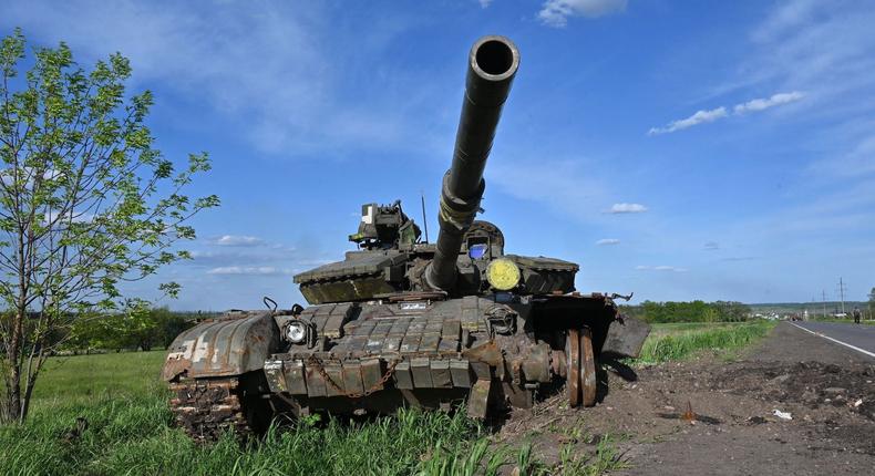 This photograph taken on May 13, 2022, shows a damaged tank on a road near the Vilkhivka village east of Kharkiv, amid Russian invasion of Ukraine.