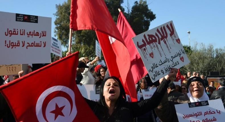 Tunisian women shout slogans during a demonstration outside parliament against allowing Tunisians who joined the ranks of jihadist groups to return to the country, in the capital Tunis on December 24, 2016