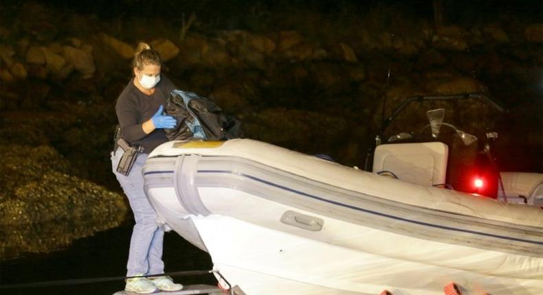 A New South Wales police officer seizes cocaine from an inflatable boat at Brooklyn on the Central Coast near Sydney