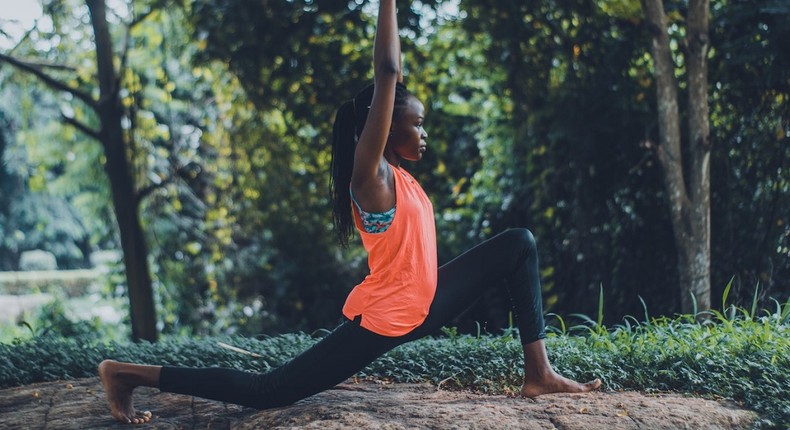 A woman showcasing a yoga pose outdoors [Photo: Oluremi Adebayo]