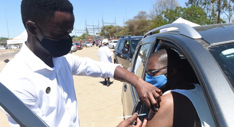 A man receives the COVID-19 vaccine at a drive-through COVID-19 vaccination site in Gaborone, Botswana, on October 12 2021