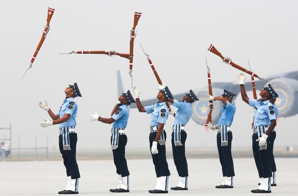 Indian Air Force soldiers toss their rifles as they perform during the full-dress rehearsal for Indi