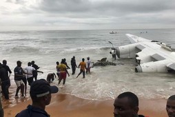 People pull the wreckage of a propeller-engine cargo plane after it crashed in the sea near the international airport in Ivory Coast's main city, Abidjan