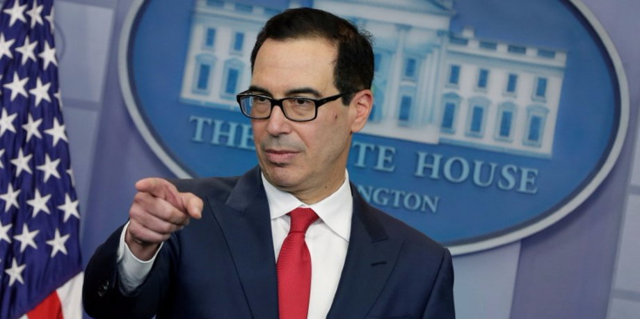 U.S. Treasury Secretary Mnuchin gestures during a news briefing at the White House in Washington