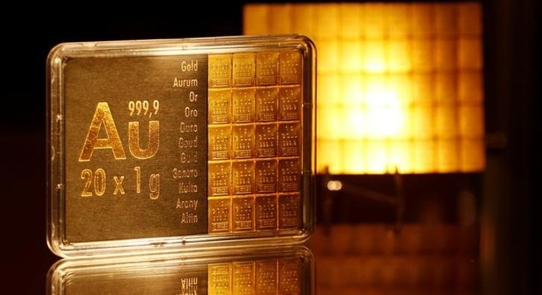 The symbol AU for the chemical element of gold is seen next to one-gram gold bars on display at the annual meeting of German Sparkasse savings banks in Duesseldorf, Germany, April 27, 2016. 