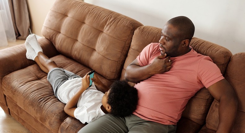 Father and son relaxing on a sofa (Photo: August de Richelieu) 