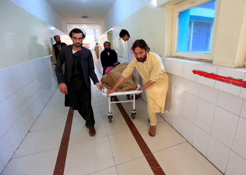 An injured man receives treatment in a hospital, after blasts at a sports stadium, in Jalalabad city