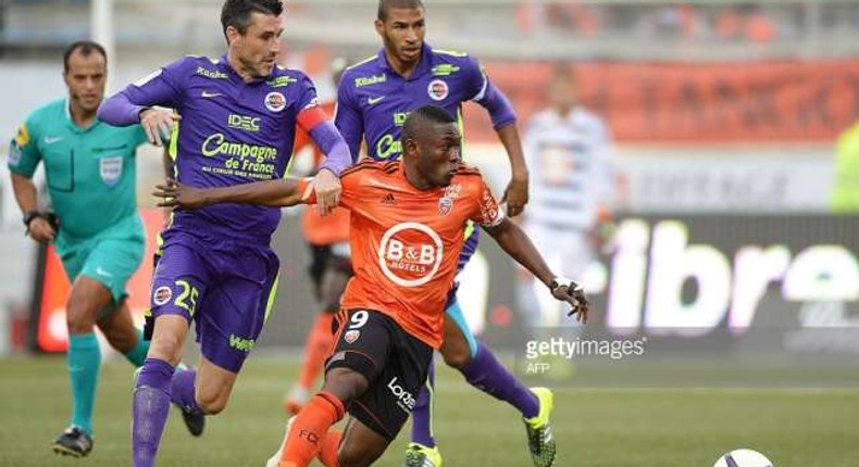 Majeed Waris in an orange color jersey