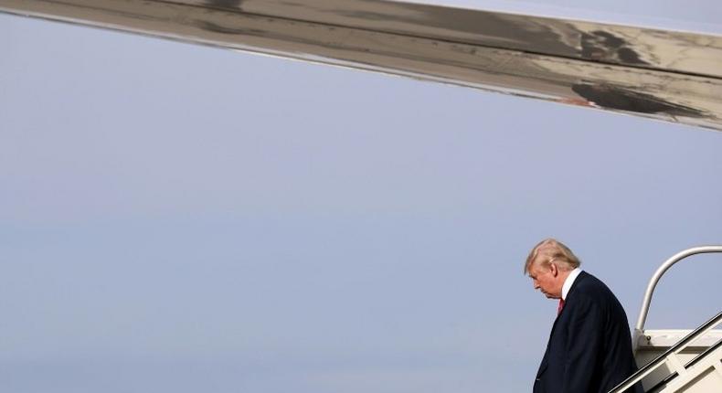 Republican presidential nominee Donald Trump steps off of his airplane at Detroit Metropolitan Wayne County Airport before heading to a campaign rally in Warren October 31, 2016 in Romulus, Michigan