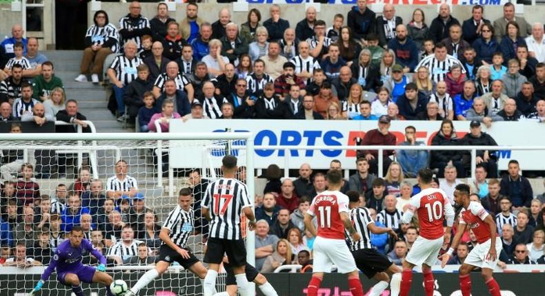 Mesut Ozil (second right) scores Arsenal's second goal in a 2-1 win away to Newcastle in the English Premier League on Saturday
