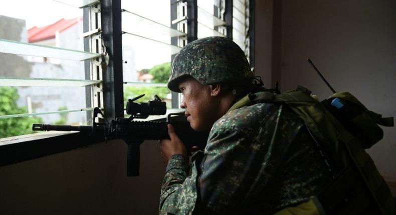 A Philippine Marine in July 2017 observed Islamic militant positions on the frontline in Marawi on the southern island of Mindanao. The US is weighing sending additional support to help the fight against IS