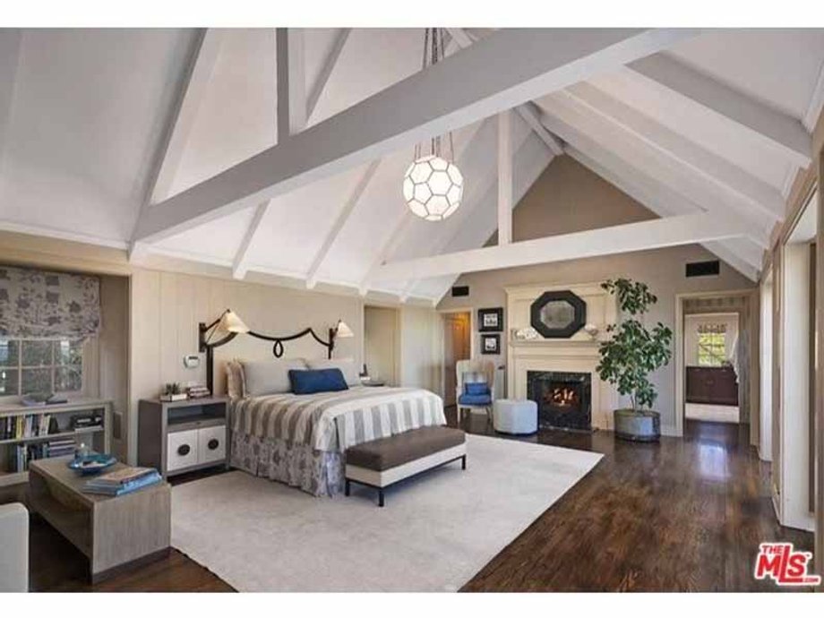 The bedroom features a dramatic cathedral ceiling.