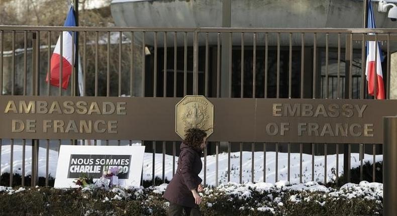 A woman walks past a French Embassy in a file photo. REUTERS/Gary Cameron