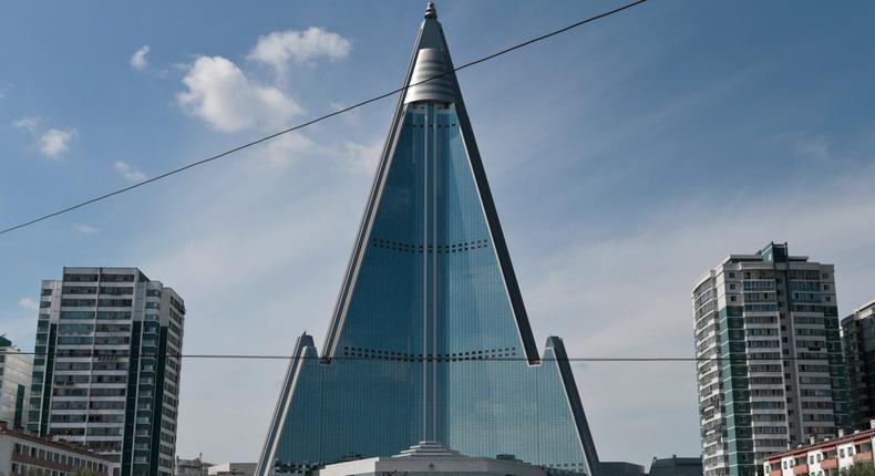 A traffic policeman stands in front of the Ryugyong Hotel in 2019.Dita Alangkara/AP