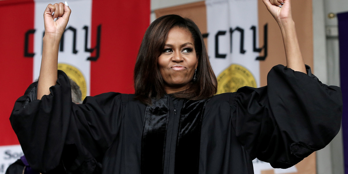 US first lady Michelle Obama reacts to cheers from graduating students before receiving an honorary doctorate of humane letters from City College of New York during the school's commencement ceremony in New York, New York, on June 3.