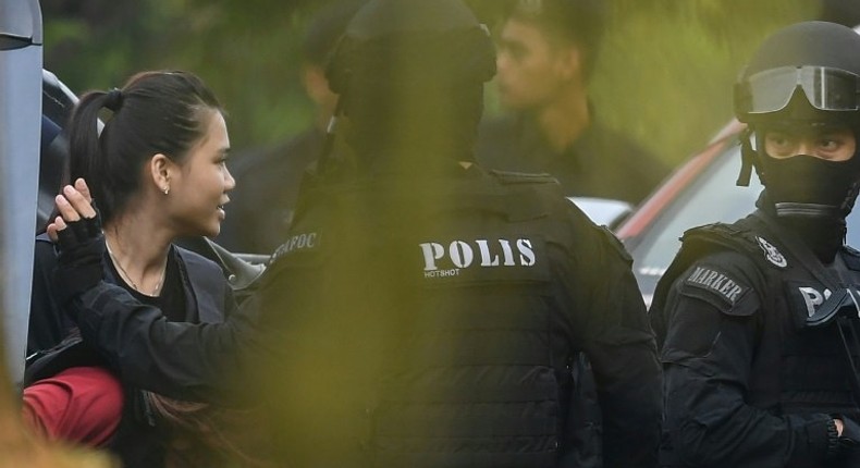 Indonesian national Siti Aisyah, one of the two acused, is taken into court with a Malaysian police escort