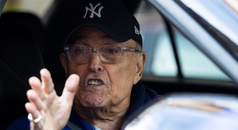 Rudy Giuliani gestures while traveling by car near pro-Palestinian demonstrators outside Columbia University, in New York City, US, April 23, 2024.Caitlin Ochs/ Getty Images