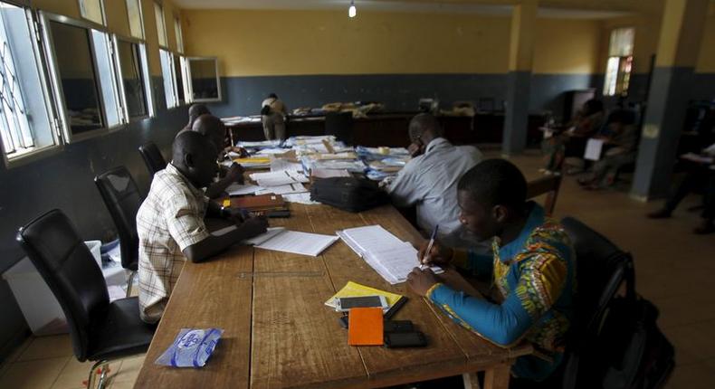 Election officials examine votes at a results centralization center at Ratoma two days after a presidential election in Conakry, Guinea October 14, 2015. REUTERS/Luc Gnago