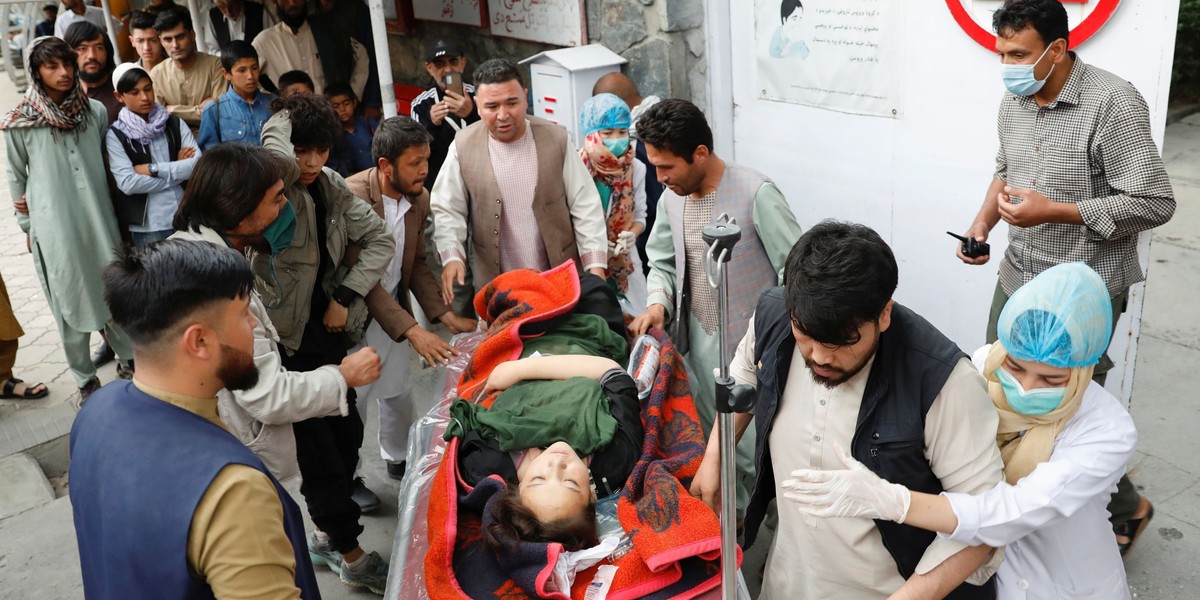 An injured woman is transported to a hospital after a blast in Kabul