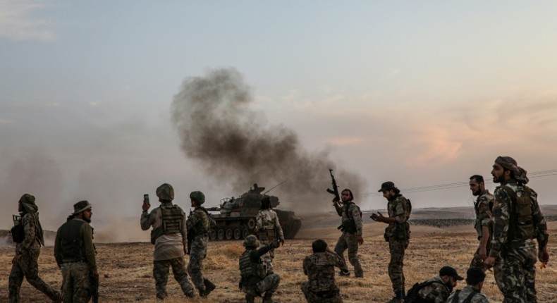 Turkish soldiers and Turkey-backed Syrian fighters on the outskirts of the Syrian city of Manbij near the Turkish border