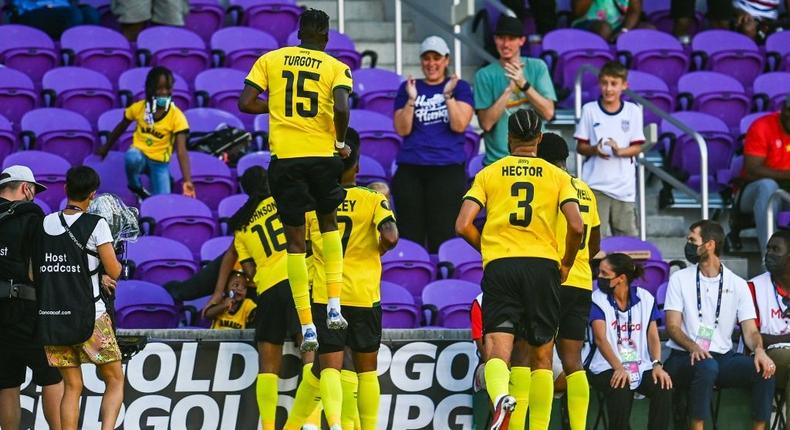 Jamaica's players celebrate after scoring against Guadeloupe Creator: CHANDAN KHANNA