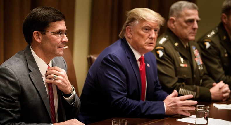 US Defense Secretary Mark Esper, left, President Donald Trump, center, and Chairman of the Joint Chiefs of Staff Army Gen. Mark Milley, right, wait for a meeting with senior military leaders in the Cabinet Room of the White House on October 7, 2019.
