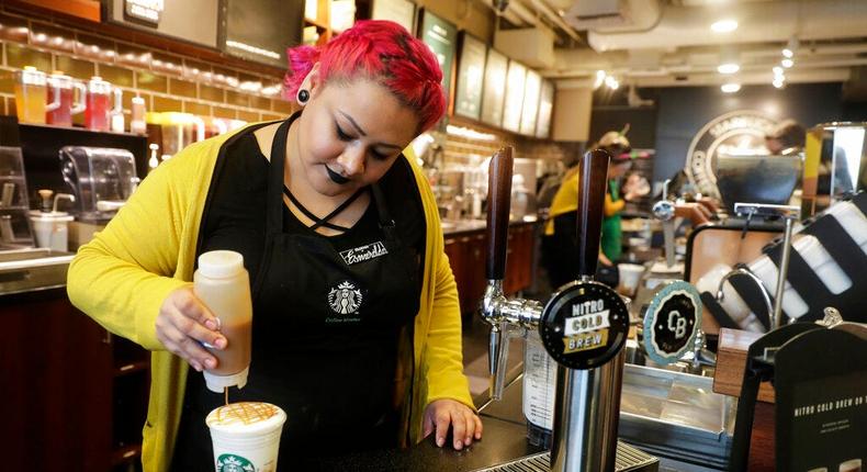 This Starbucks barista is making one of its many drinks with a smile. But the menu has gotten out of hand!Ted S. Warren/AP